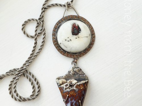 Art pendant featuring plume agate and lampwork cabochon set in sterling silver and copper