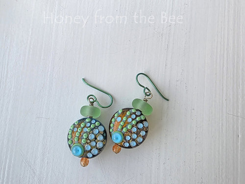 Artisan glass earrings in shades of orange, aqua and green