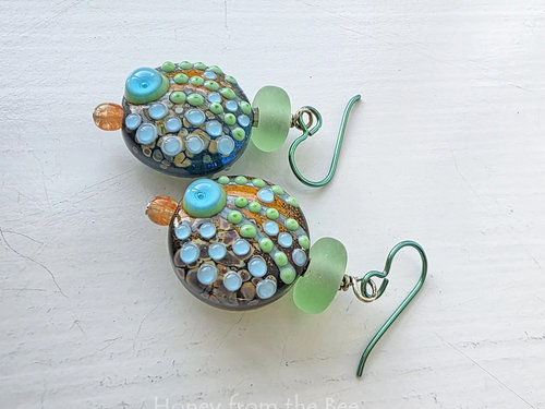 Colorful earrings in orange, green and aqua