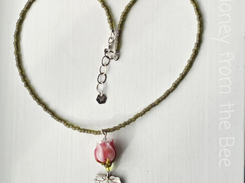 Bridesmaid necklaces feature pink rosebuds and silver leaf