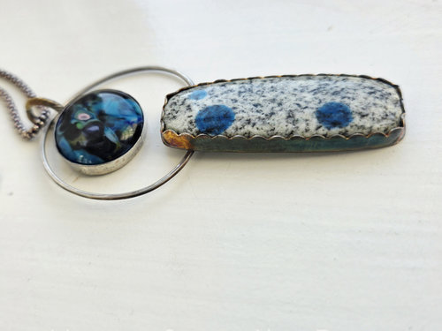 Silver and blue pendant features glass cabochon by Mikelene Reusse and a K2 granite cab