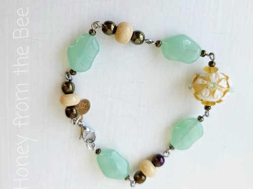 Yellow and green beaded bracelet with lampwork focal