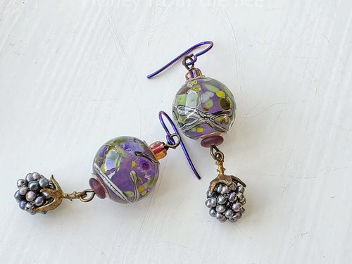 Artisan earrings feature berry dangle and lampwork in purple and green