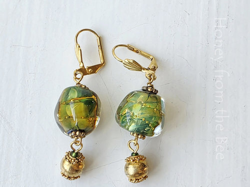 Bright green and gold earrings feature lampwork and a vermeil dangle