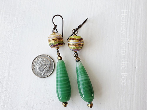 Statement earrings in green and gold