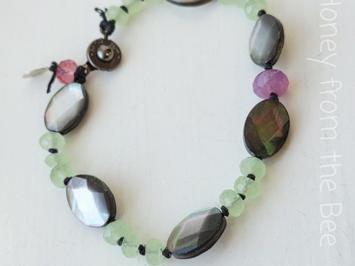 Artisan bracelet in grey, green, and pink