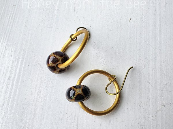 Giraffe print earrings on gold hoops