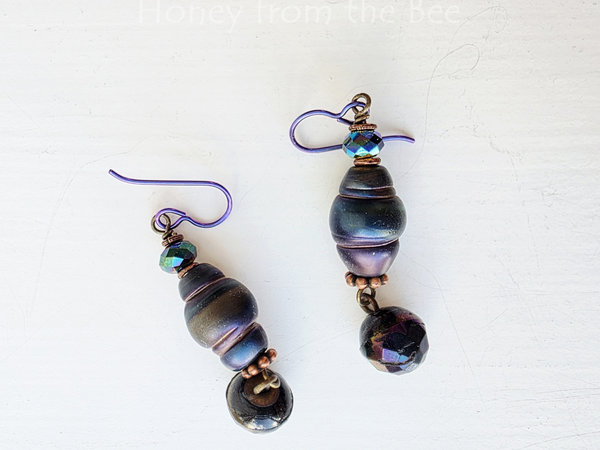 Dark peacock colored earrings in organic shape